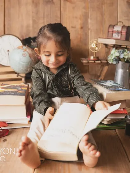Lost in a story. This little one is engrossed in a book, a beautiful, quiet moment during his themed session.