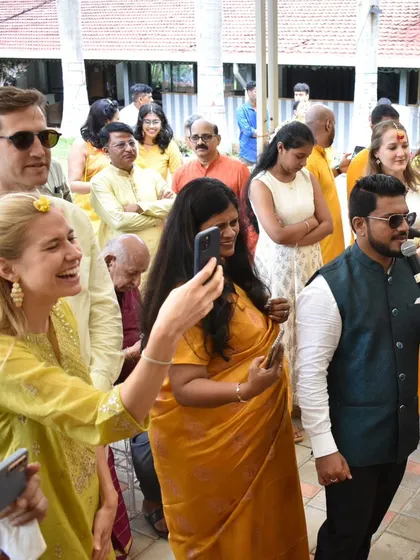 Hosting a Haldi ceremony with international guests. I guide them through the rituals, making sure they feel part of the celebration.