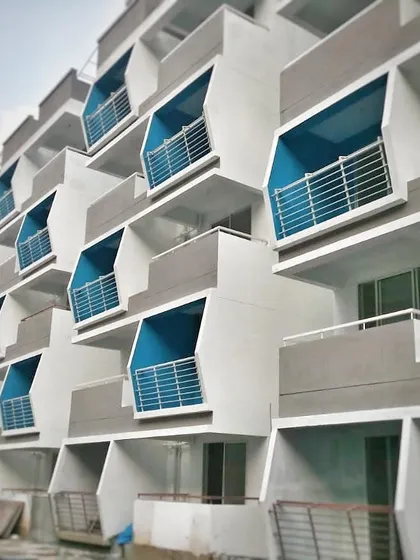 A work-in-progress shot of the Mars Mount apartments. This view shows the repeating module of the angled balconies before final finishing, revealing the underlying structure of the facade.