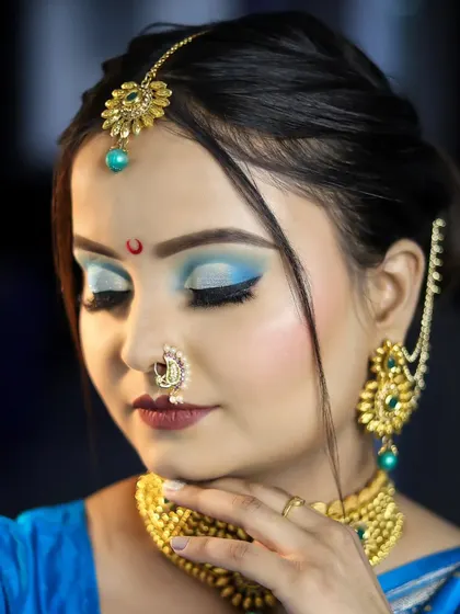 This close-up on the eye makeup shows a perfect cut-crease with a pop of blue, demonstrating an advanced technique taught in our courses.