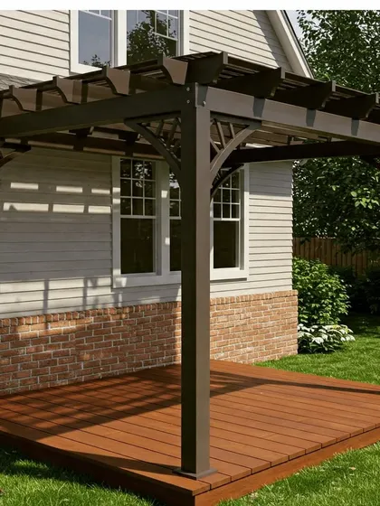 A traditional dark brown pergola with decorative corner braces, installed on a wooden deck. The design complements the classic architecture of the adjacent house.
