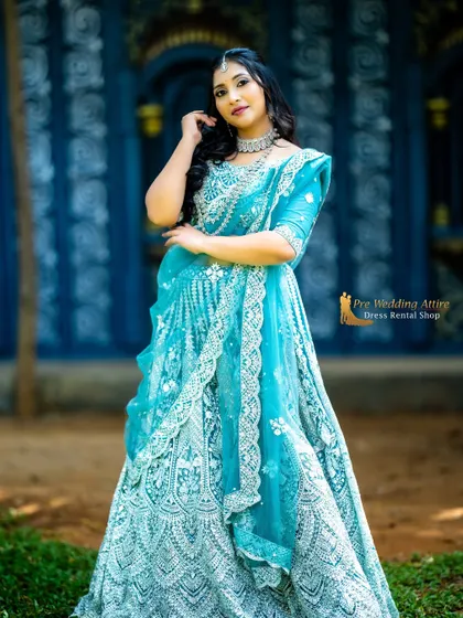 A stunning sky blue lehenga with heavy white and silver embroidery. The net fabric is lightweight and comfortable, while the intricate work gives it a grand appearance.
