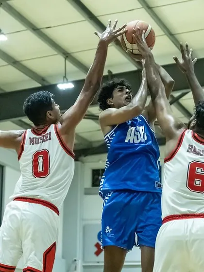 Battling for the rebound in a tough match. Physicality and grit are non-negotiable in these high-stakes games.