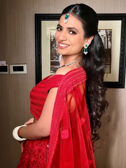 Soft glam at its finest for this post-wedding celebration. A bouncy ponytail and radiant makeup create a look that is both chic and comfortable.