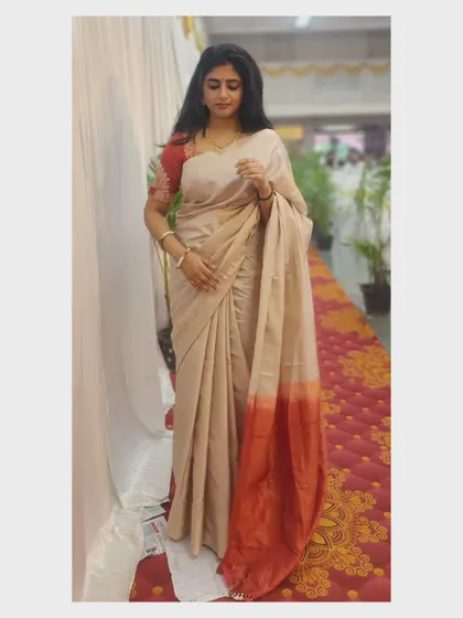 A simple yet elegant beige and red saree. This classic look is versatile for any formal or traditional event.