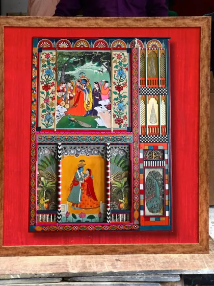 The completed artwork, framed against a vibrant red Banarasi silk. The five-month journey from scrap to story is complete, with the panel now a fine art piece ready to be displayed.