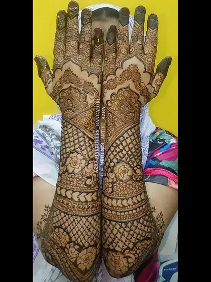 A full bridal design for a bride named Azra, featuring traditional patterns and full coverage up to the elbows.