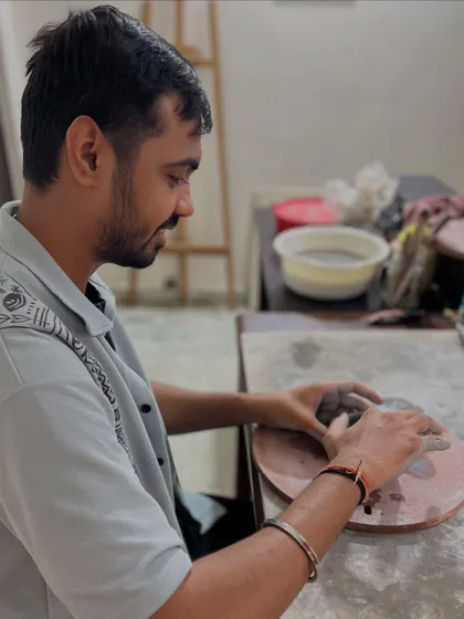 A quiet moment of focus during an anniversary clay date. The studio provides a peaceful backdrop for couples to slow down and enjoy the creative process together.