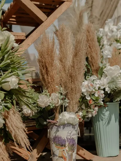 A close-up of the floral arrangements, featuring pampas grass and white flowers for a soft, neutral look.