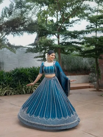 A full-length shot of this beautiful blue lehenga from a designer shoot. The makeup is kept clean and elegant to let the outfit shine.