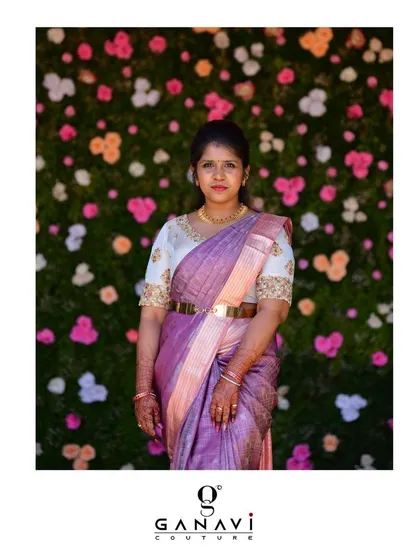 Nandu posing against a floral backdrop, her pastel ensemble looking fresh and elegant. This look is perfect for a daytime wedding or festive event.