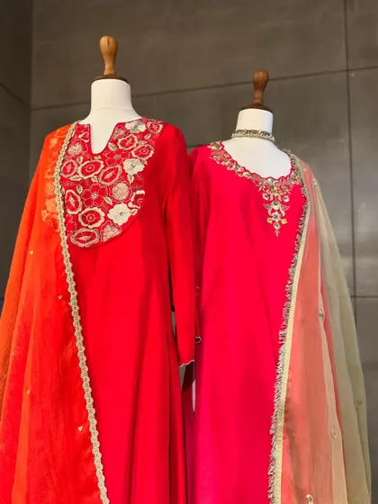 Bright and beautiful. These red and orange suits with delicate embroidery are perfect for adding a pop of color to your festive wardrobe. The ombre dupatta adds another layer of interest.
