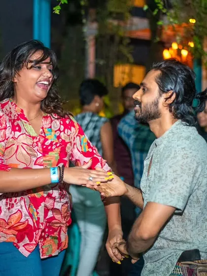 A happy and relaxed couple. The floral shirt and jeans are perfect for a casual dance night.