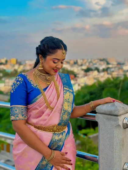 A beautiful outdoor shot from a bridal photoshoot. The soft, glowing makeup looks stunning against the city skyline at dusk.