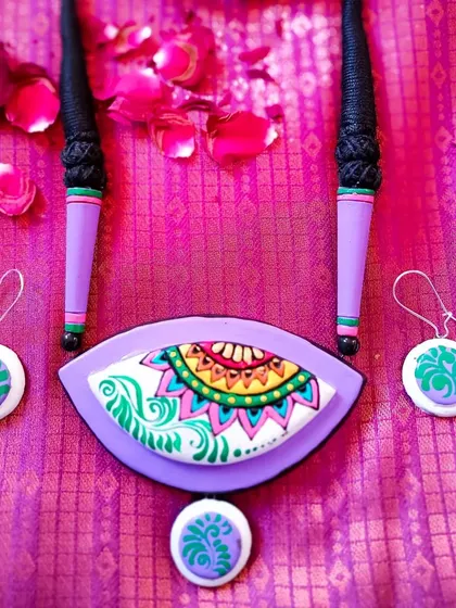 The same fish-eye shaped necklace in a soft lavender and green combination.