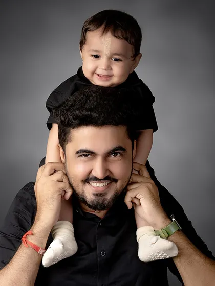 The best seat in the house! A happy baby enjoys a ride on his father's shoulders, a classic and heartwarming pose that shows their special bond.