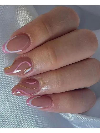 Soft and sweet, this design features abstract pink and white swirls with a hint of gold glitter, offering a playful and modern alternative to the traditional French manicure.