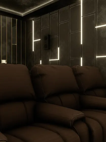 A close-up of the comfortable brown leather recliners, set against the unique, illuminated wall panels.