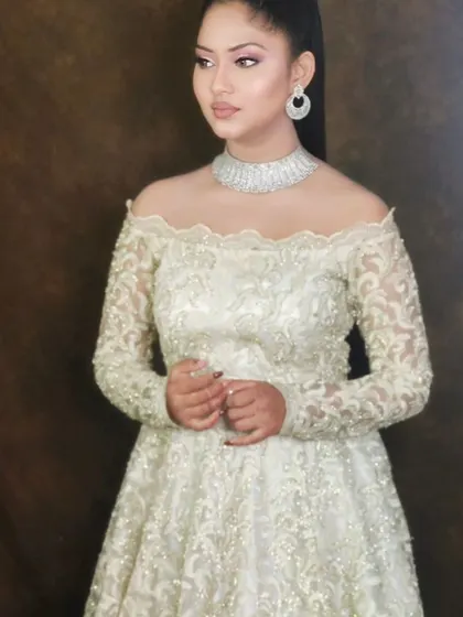 A simple yet stunning look. This white gown is paired with a delicate American Diamond choker and minimalist earrings, showing that modern elegance is all in the details.
