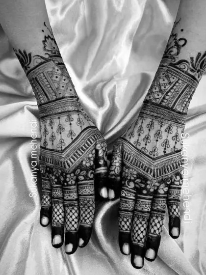 A black and white photo to highlight the pure artistry of the design. The focus is on the clean lines, geometric patterns, and floral details of this full-hand mehendi.