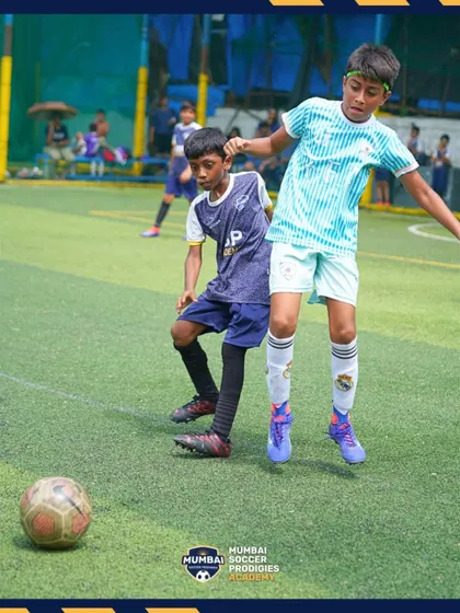A young player shows determination as he fights for the ball during a competitive match.