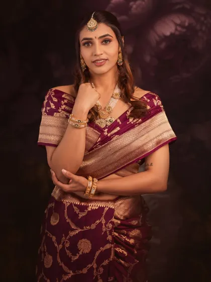 Sapthami's pose is one of modern confidence, yet her traditional Banarasi saree roots her in timeless elegance.
