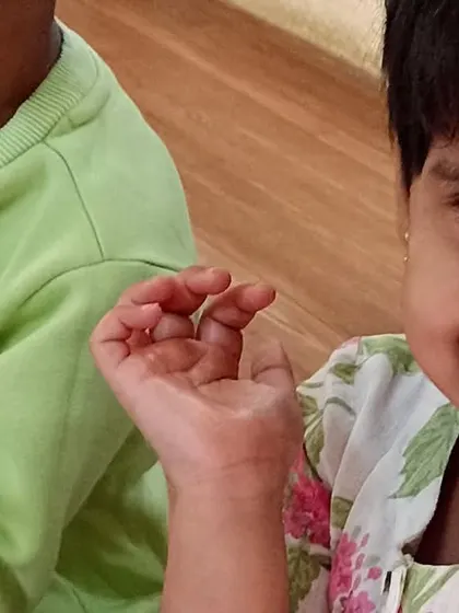 A close-up of a smiling child, happy with the healthy and tasty snack.