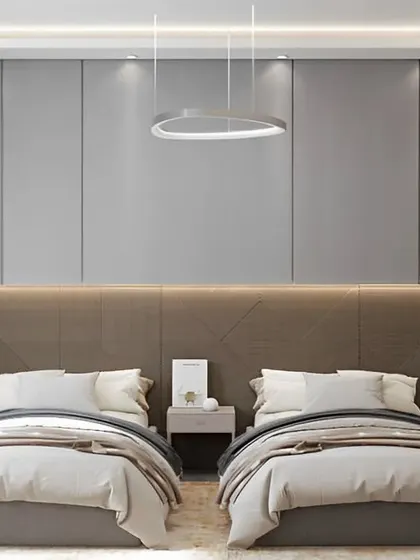 A shared bedroom design that maintains a sense of personal space and elegance. The dual beds are framed by a sophisticated headboard and wall paneling, with individual pendant lights for reading.