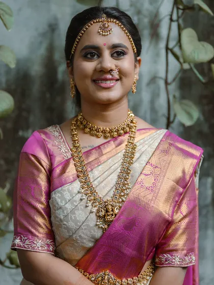 A smiling portrait of the bride, looking radiant on her wedding day in Delhi.