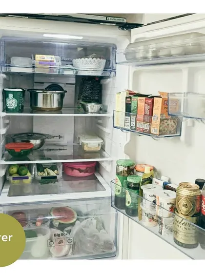 The "after" of the same fridge. By categorizing items and using the door space effectively, the fridge is now tidy and it's easy to see everything you have.