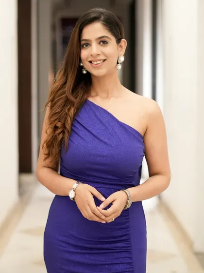A portrait in the blue gown. The simple elegance of the dress is complemented by pearl earrings, completing the look.