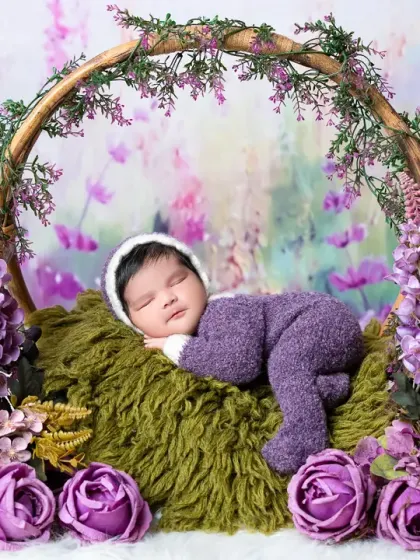 A wider view of our lavender-themed newborn session, showing the baby peacefully asleep in a basket hoop. I use layers of texture and color to create rich, artistic newborn photos.