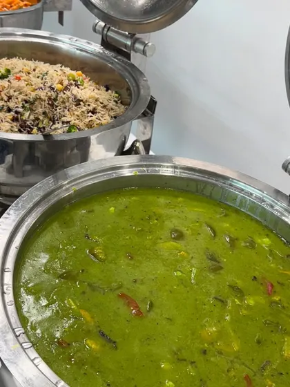 We offer a variety of international dishes for our corporate clients. This is our creamy Green Thai Vegetable Curry, served alongside Mexican Rice, part of a global menu curated for an office lunch.