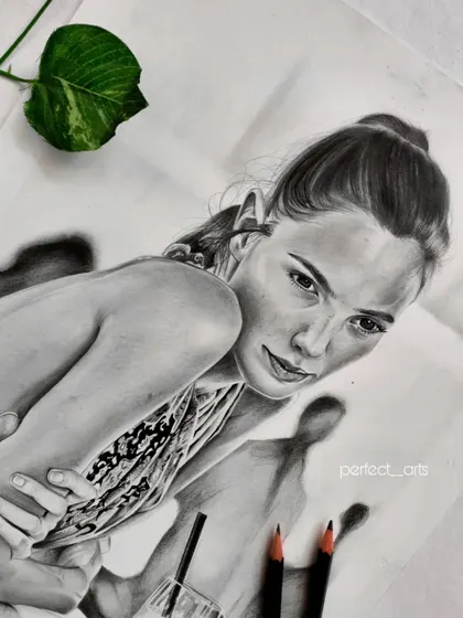 Another angle of the Gal Gadot portrait, showing the finished work next to my pencils. This view highlights the subtle shading and highlights that bring the drawing to life.