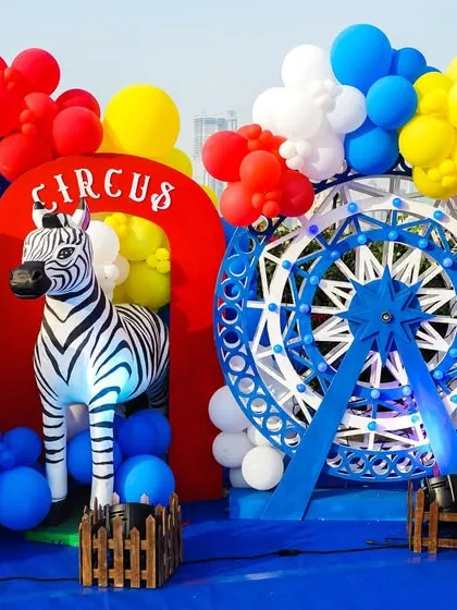 A close-up of the circus decor, featuring a light-up number '1', a zebra prop, and a lion on a pedestal.