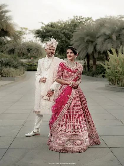 Walking together into their future. This full-length portrait showcases the couple's stunning wedding attire against a clean, modern backdrop at the Sheraton Grand.