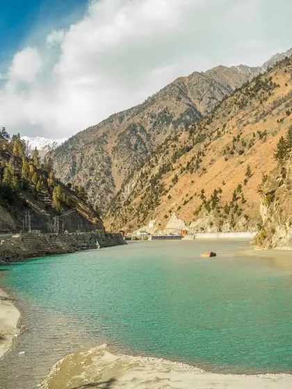 A collection of breathtaking landscapes from Spiti. These images feature the majestic snow-capped peaks, the turquoise river, and the dramatic, winding roads carved into the mountainside.