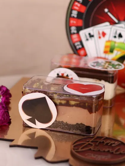 A close up of the Hazelnut Belgian Chocolate dessert tub from our Diwali platter, decorated with a spade card suit sticker.