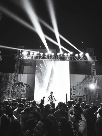 A black and white shot of an outdoor performance in Delhi. The stage, lighting, and packed audience demonstrate my ability to command a large open-air venue.