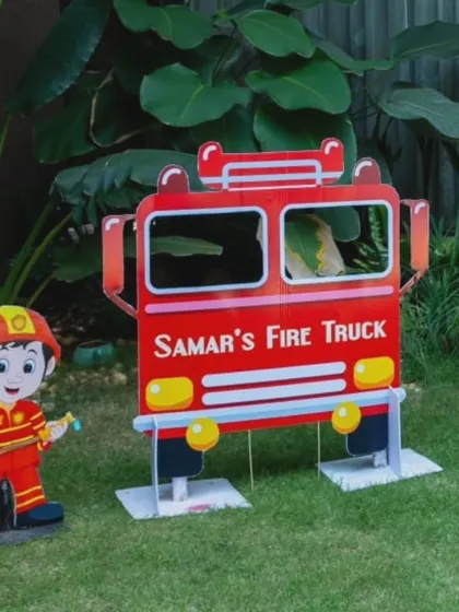The fire truck prop and a firefighter cutout, creating a perfect themed photo opportunity.