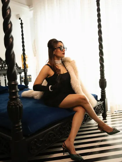 A full-length shot showing how the 90s puff hairstyle complements the entire retro-glam outfit. It's a chic and confident look, perfect for a themed party.