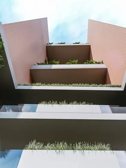 A worm's-eye view of the symbiotic residential building, looking up through the open terraces. This perspective highlights the integration of greenery at multiple levels and the dynamic, angular geometry of the design.