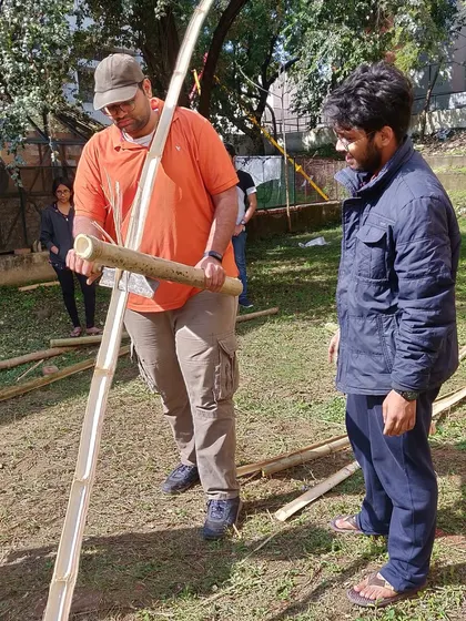 **People of Compartment S4: Monik Shah:** Monik working with bamboo, showcasing his hands-on approach and experimentation with natural materials like stone, wood, and mud.