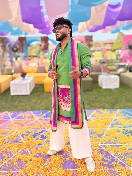 Posing on a floor strewn with flower petals, my traditional outfit feels right at home.