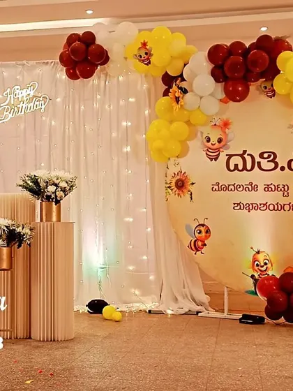 This is an example of the beautiful themed decor we can arrange for a first birthday, including custom banners in Kannada like this one reading 'Happy First Birthday'.