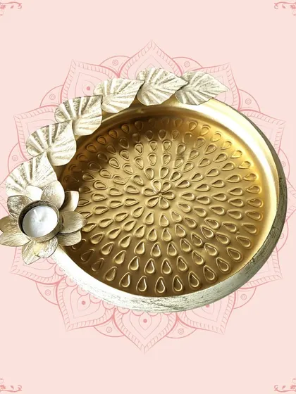 A golden platter with a distressed white finish and a floral T-light holder. This versatile piece is perfect for serving or as a decorative centerpiece.