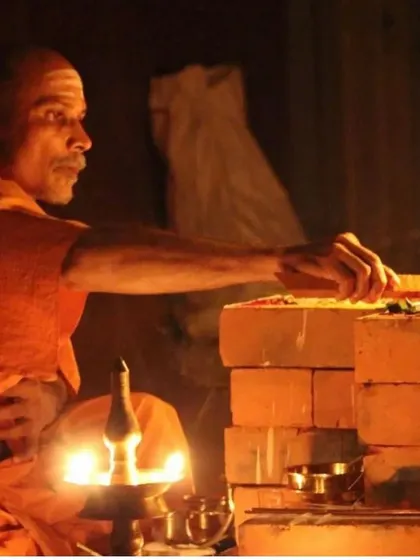 A close-up of the fire ceremony. The focus and devotion required for these rituals are a form of meditation in themselves.