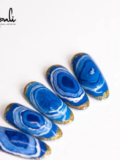 I call this my 'sea effect' design. The deep blues and whites, edged with gold glitter, remind me of ocean waves and agate stones.