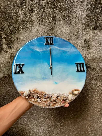 Here’s one of my most popular creations, the ocean-themed resin wall clock. I use real sand and shells to create a miniature beach scene, and the layered resin waves give it a realistic 3D look. It's a beautiful piece of functional art for any home.