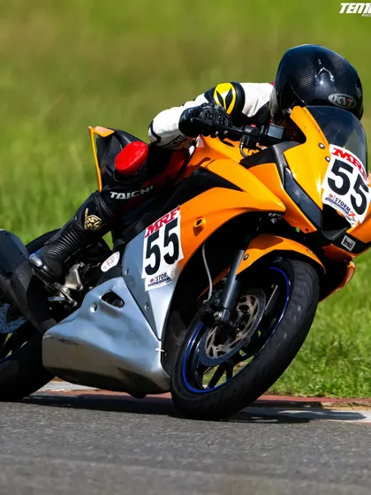 This shot captures the aggressive yet controlled posture required for competitive racing. Our riders learn to use their body weight to steer the bike and maintain stability through corners.